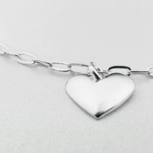 a silver heart charm on a silver chain