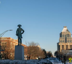 a statue of a man standing in the middle of a street